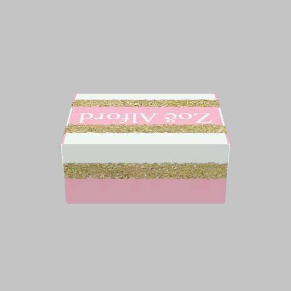 A Custom Mailer Box by 105 Packaging with a pink and gold glitter-like striped design featuring the text "Zoe Alford" on the top, set against a plain gray background.