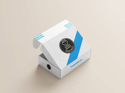 A partially opened Custom Mailer Box in white with blue accents, showcasing a custom round black and white logo on the top, placed on a light beige surface. This product is from 105 Packaging.